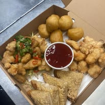 A Wokon munchie box loaded with salt and chilli chicken, chicken balls and prawn toast